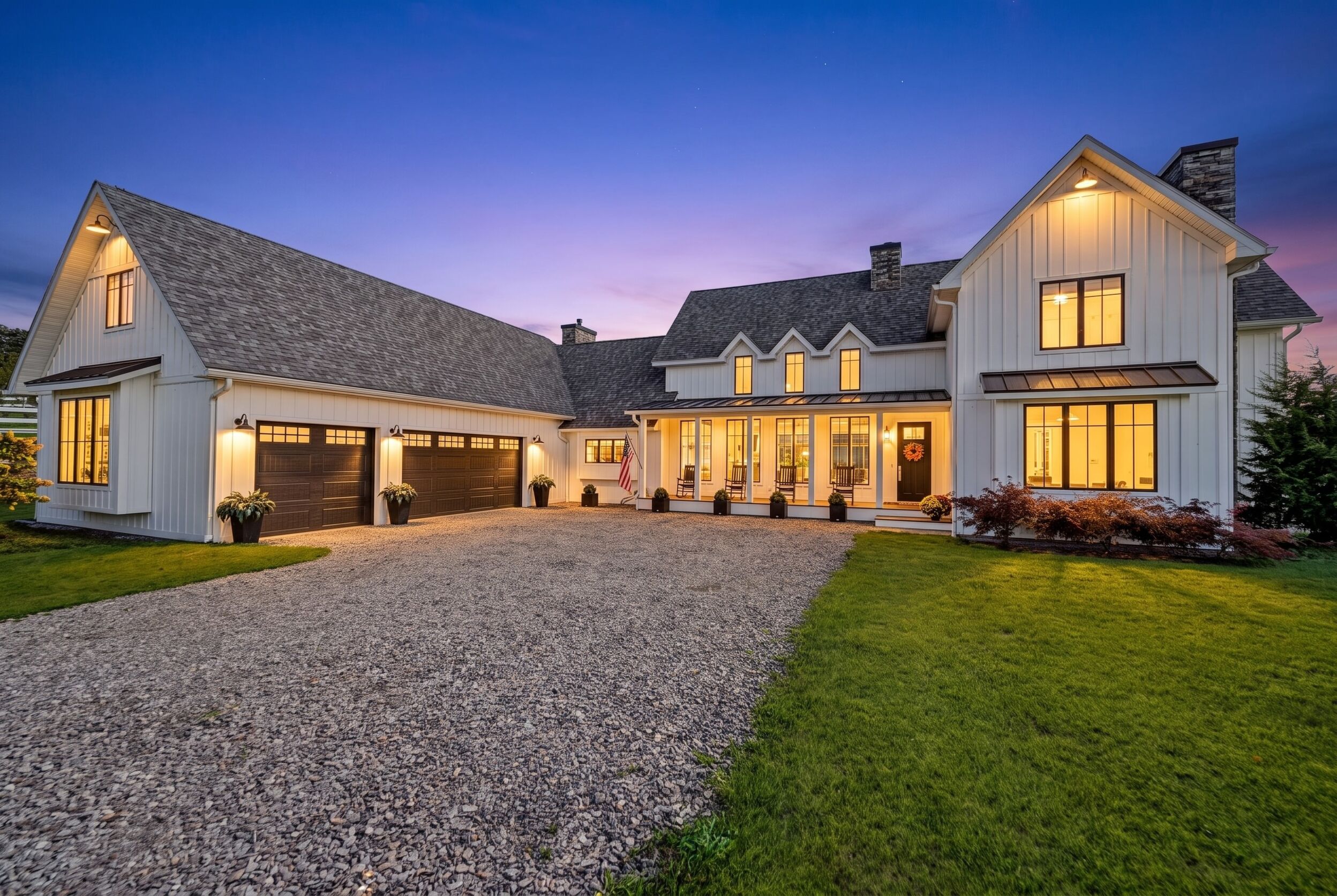 Front elevation and gravel motor court at twilight