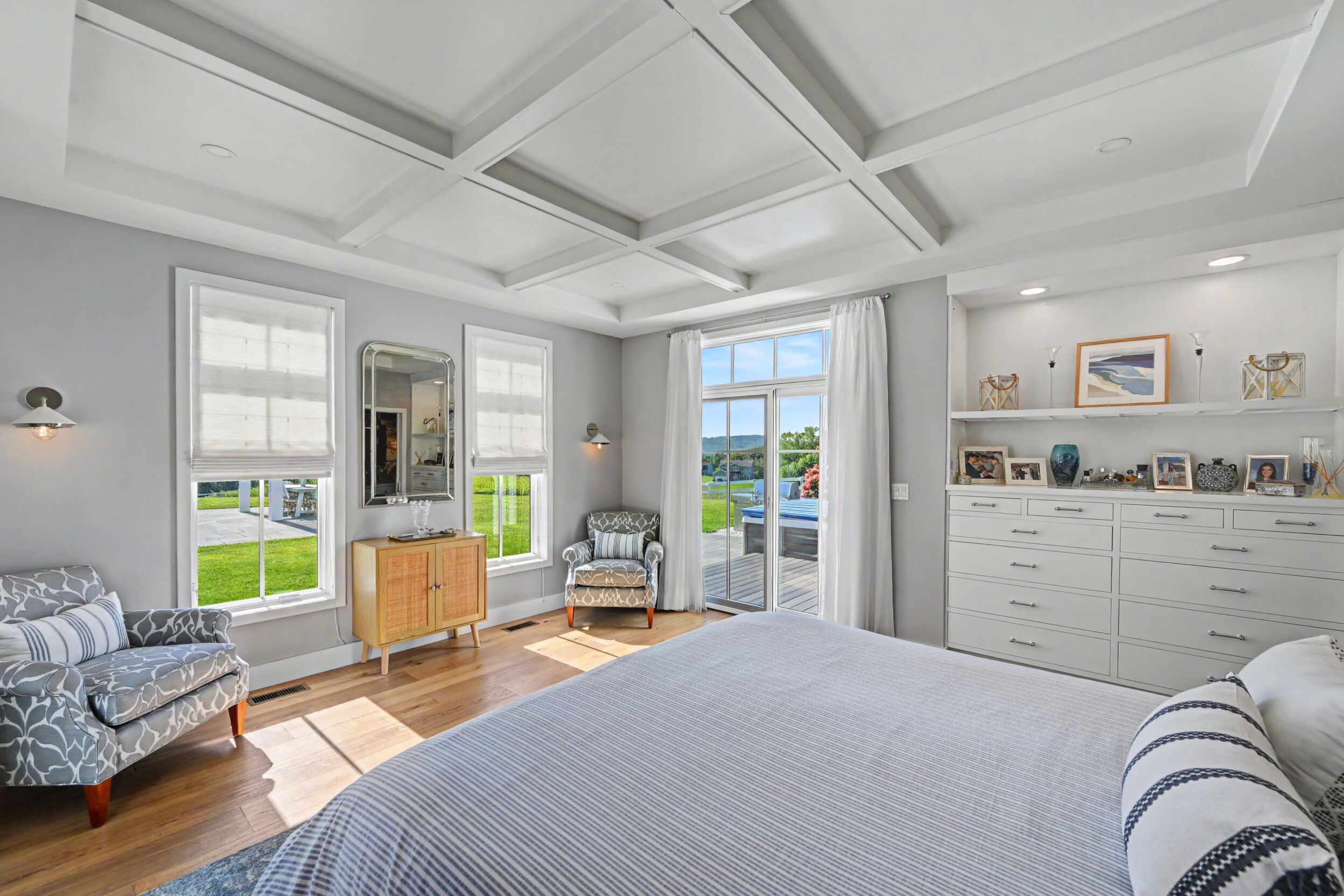 Primary bedroom built-in dresser and garden views