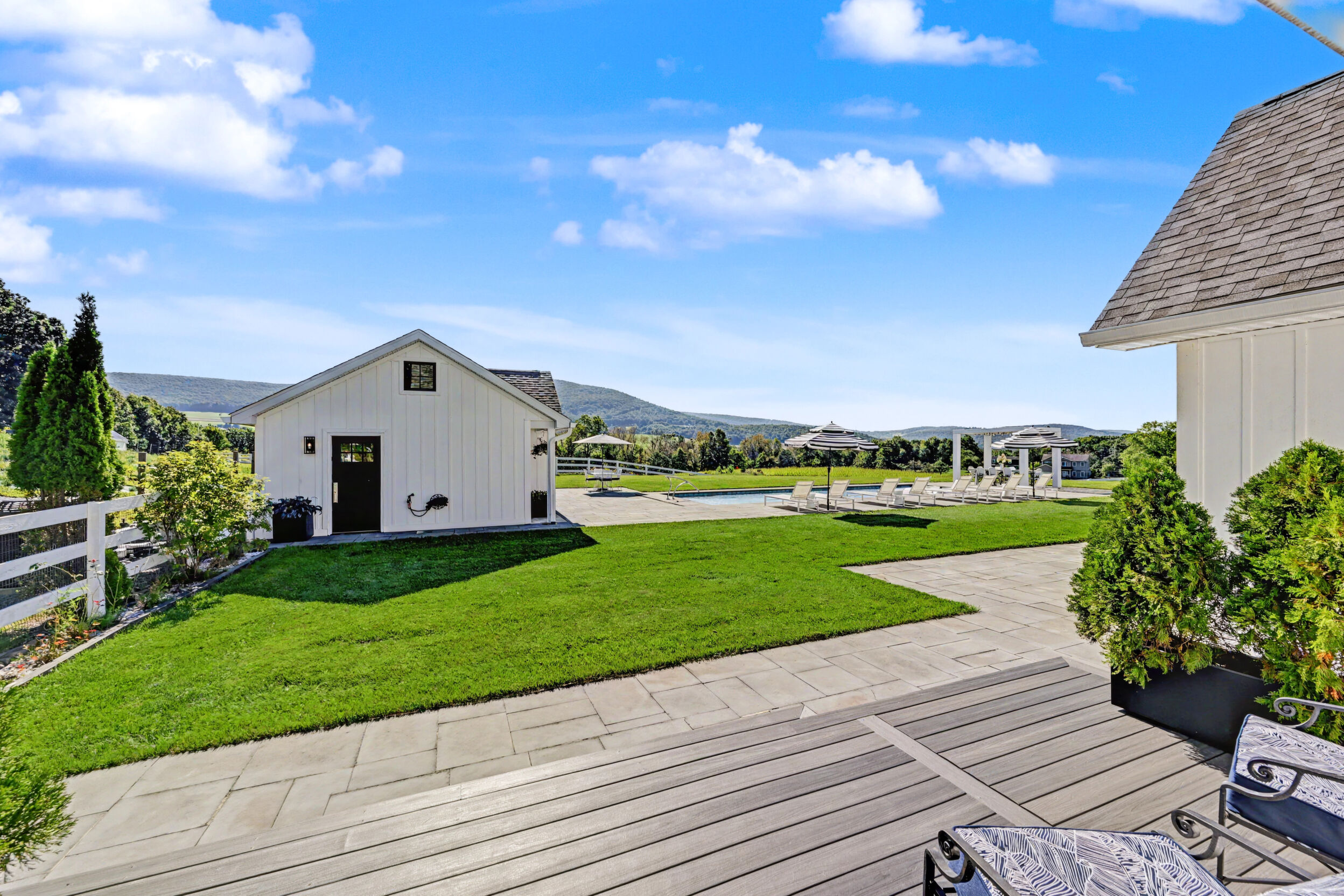 Post-and-beam main barn across the lawn