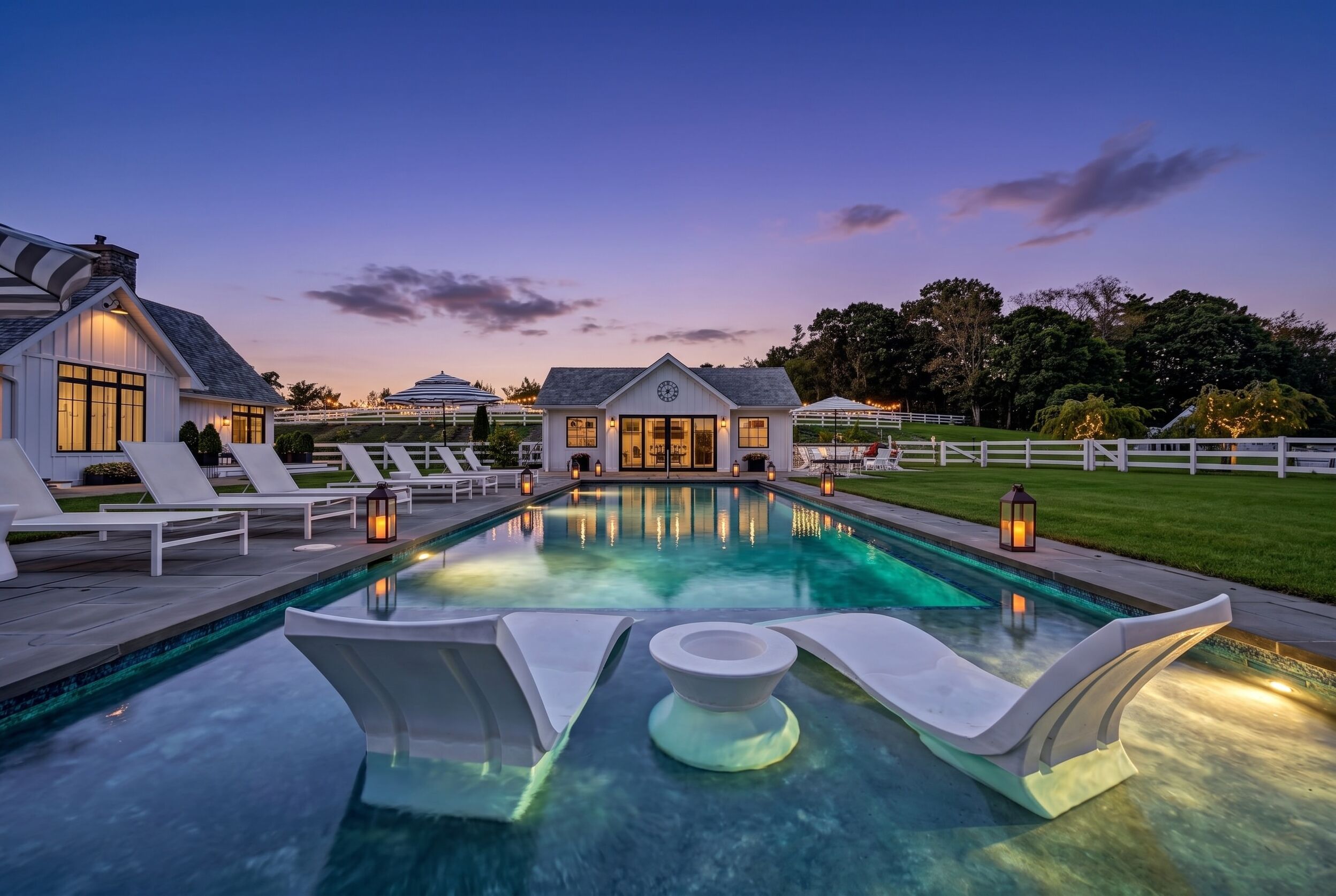 Pool and pool house illuminated at twilight