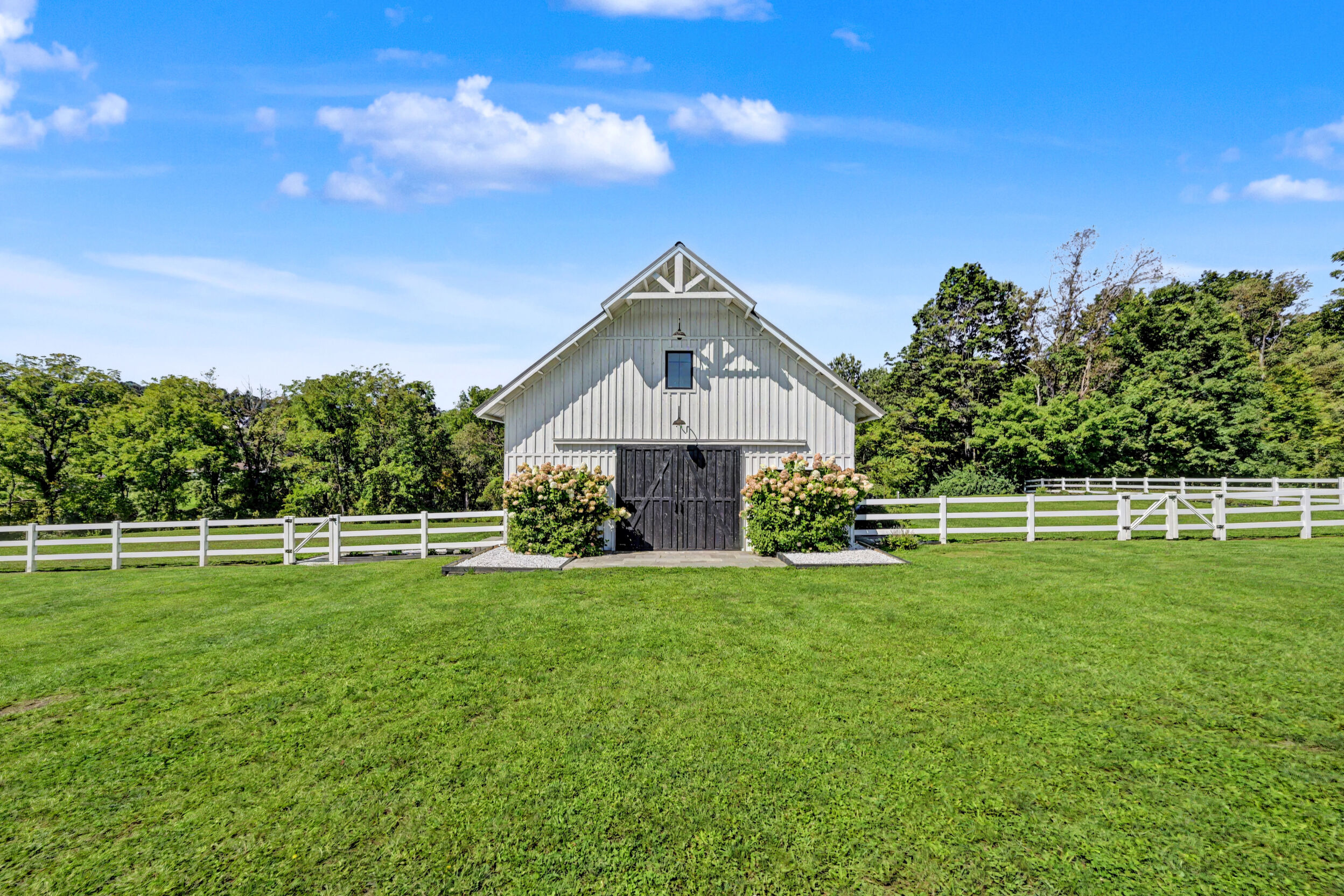 Main barn beyond the white fencing